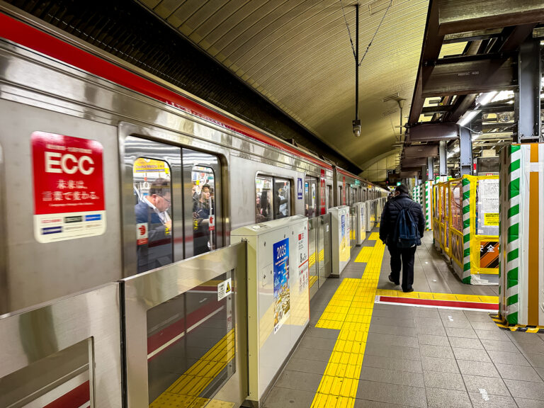 Osaka, Japan - 14.11.2023. Osaka underground platform view. Red line, Yodoyabashi station, passengers at the platform waiting for the boarding and gate opening